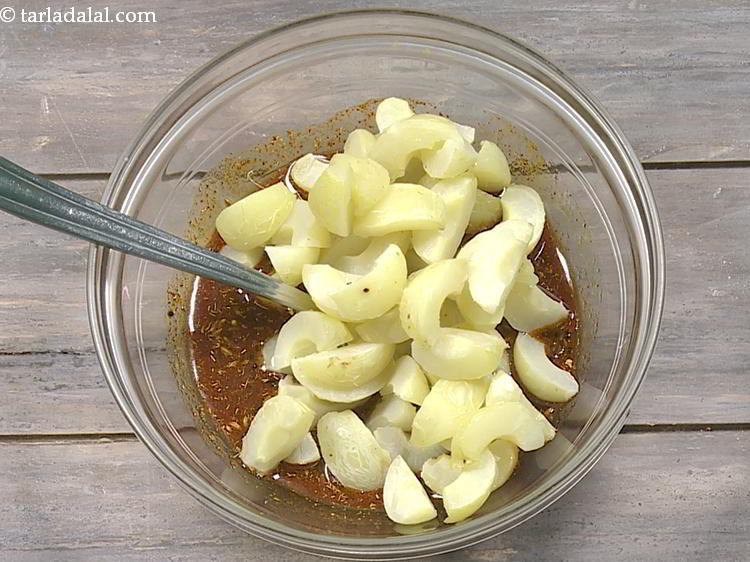Step 16 – Add the amla wedges to the mustard oil mixture.
