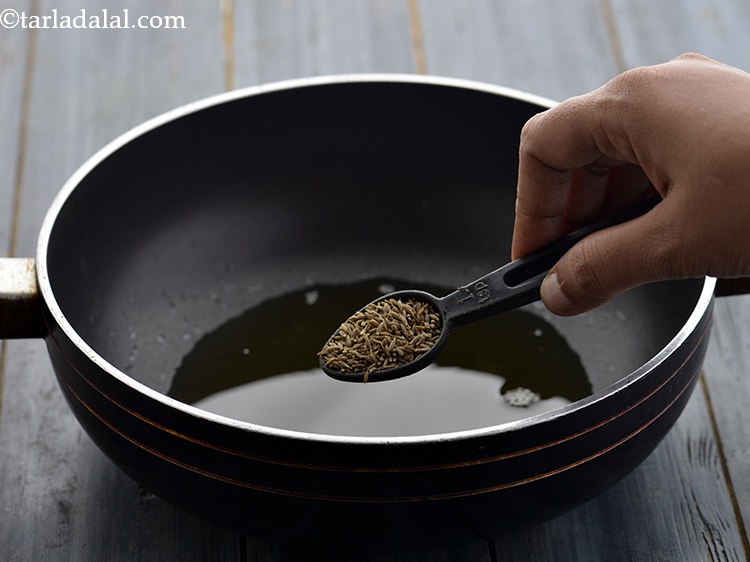 Step 15 – When the ghee is hot, add the cumin seeds.