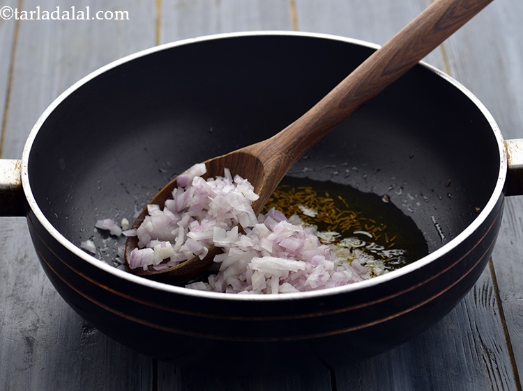 Step 16 – When the seeds crackle, add onions.