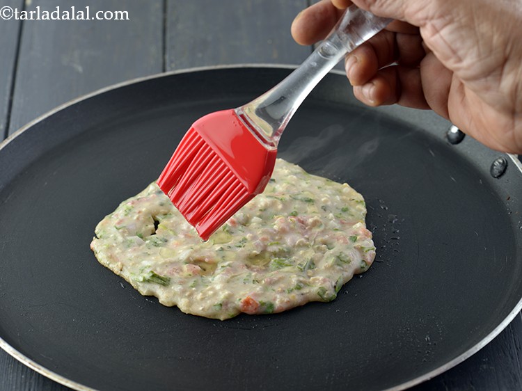 Step 13 – Cook on a slow flame till it turns brown in colour from one side.