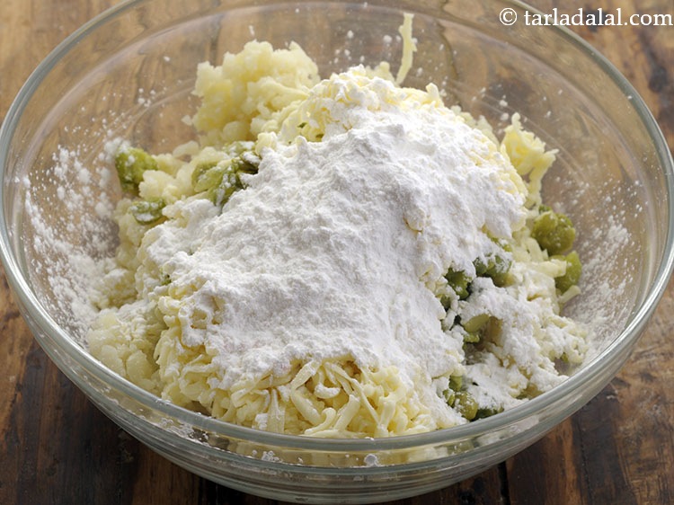 Step 19 – Add cornflour. This helps in binding together all the ingredients and prevent the potato roll …