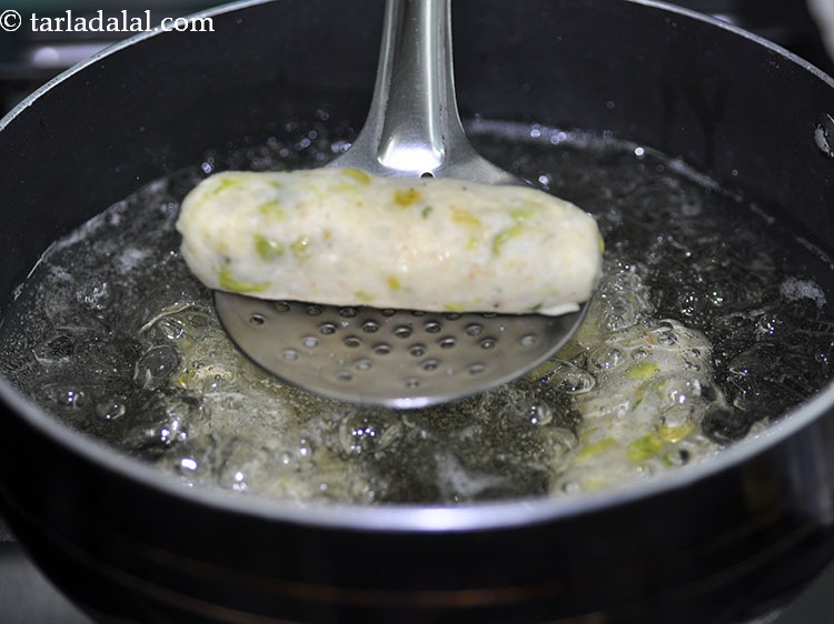 Step 26 – To cook the <strong>potato rolls</strong>, heat the oil in a deep non-stick pan and carefully …