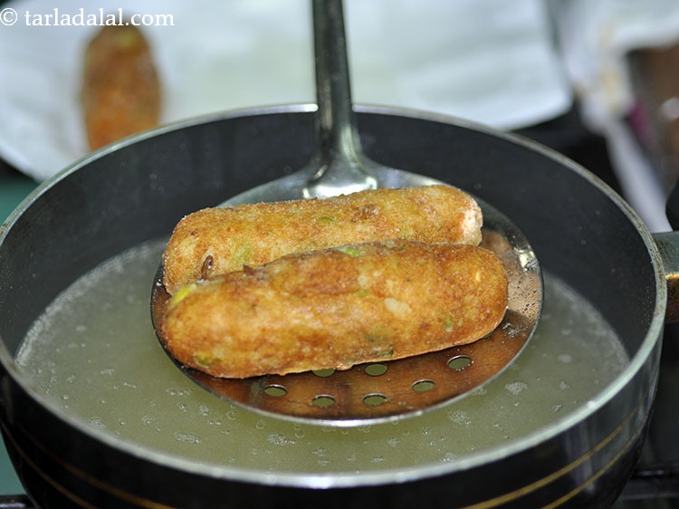 Step 27 – Fry on a medium flame till they turn golden brown in colour from all the …