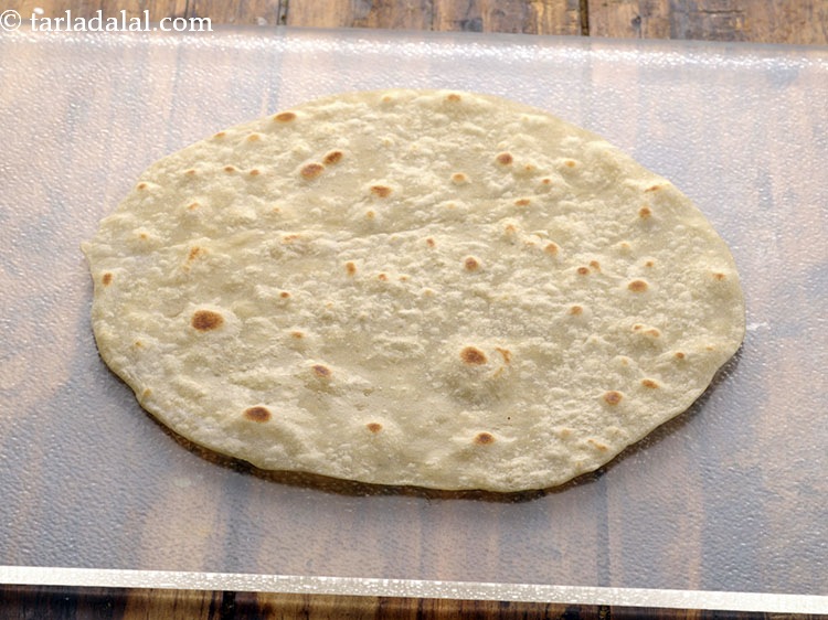 Step 40 – To assemble the <strong>spicy potato roll</strong>, place a roti on a clean, dry surface.