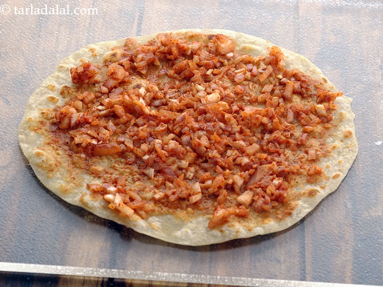 Step 42 – Put &frac12; tbsp of the prepared onion masala mixture evenly over it.