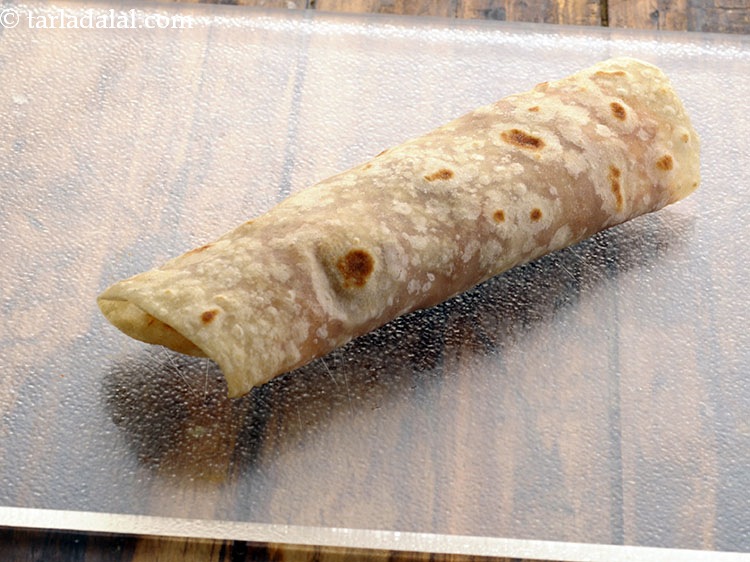 Step 44 – Roll it up tightly and our&nbsp;<strong>spicy potato and roti roll recipe | aloo green peas …