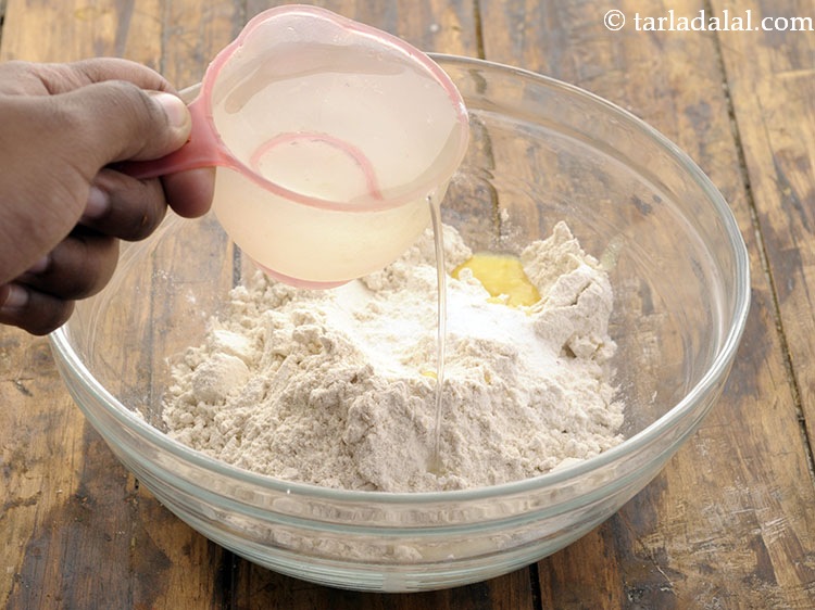 Step 6 – Combine all the ingredients in a deep bowl and gradually add water to form a …