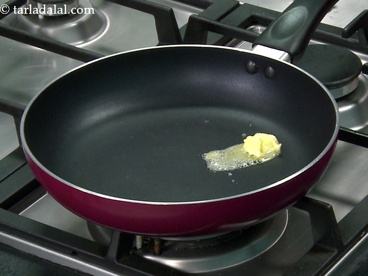 Step 17 – For the <strong>spinach topping</strong>, heat 1/2 tbsp&nbsp;<a href="https://www.tarladalal.com/glossary-butter-makhan-233i">butter</a> in a non&ndash;stick pan.