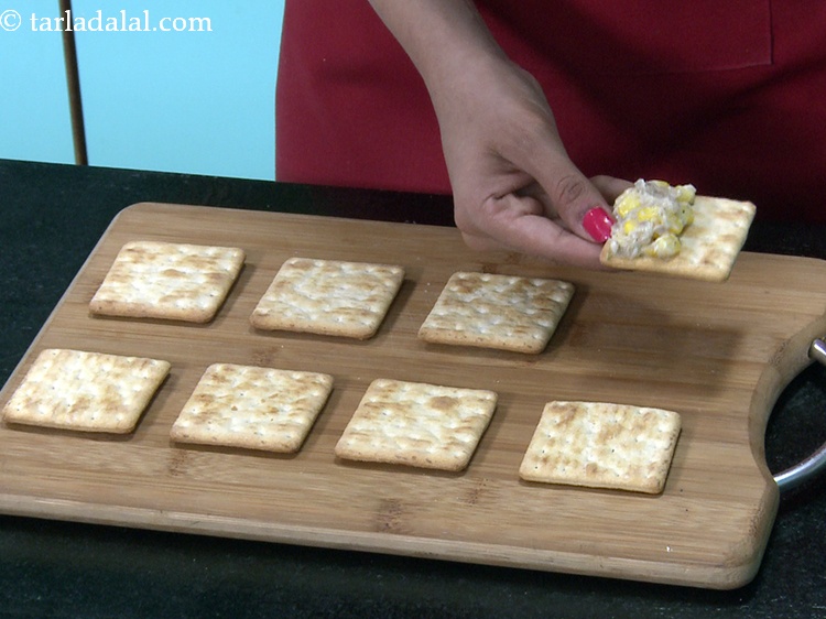 Step 32 – Spread &frac12; tbsp of the sweet corn topping on one half of the cracker.