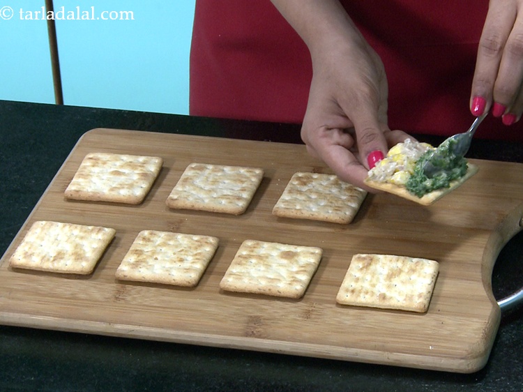 Step 33 – Spread &frac12; tbsp of the spinach topping on the other half of the cracker.