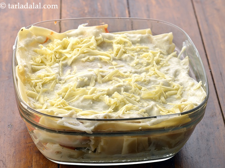 Step 63 – Sprinkle 1/4 cup&nbsp;<a href="https://www.tarladalal.com/glossary-grated-processed-cheese-868i">grated processed cheese</a>&nbsp;over it.&nbsp;