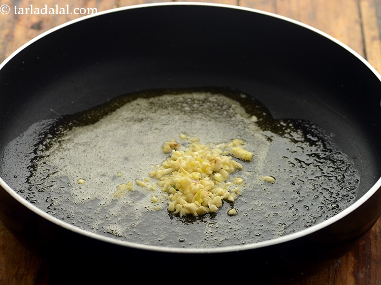 Step 8 – Once the butter is hot, add garlic. It add a nice flavour to spinach noodles.&nbsp;