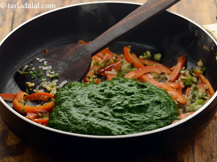 Step 13 – Add the spinach pure. Learn how to make <a href="https://www.tarladalal.com/How-To-Make-Spinach-Puree-and-Blanched-Spinach-22489r">spinach pure at home</a>.&nbsp;
