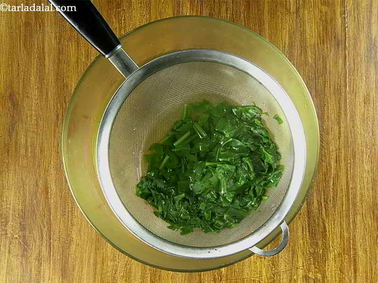 Step 7 – After 3-4 minutes, when the leaves have turned tender, drain and squeeze out the excess …