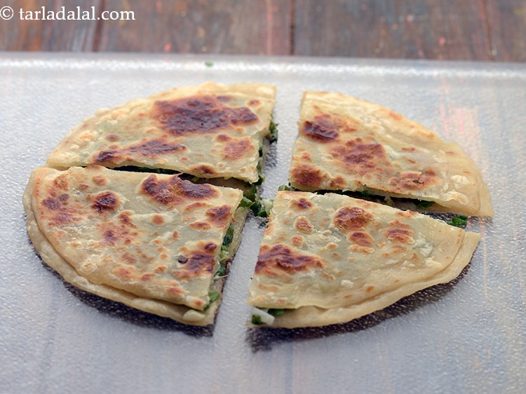 Step 23 – Cut&nbsp;<strong>spring onion paratha | hara pyaz paratha |&nbsp;</strong>into 4 equal pieces using a pizza cutter …