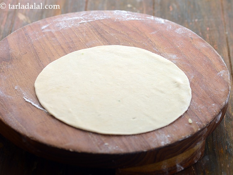Step 15 – Roll a portion into a 150 mm. (6&rdquo;) diameter circle using a little whole wheat …