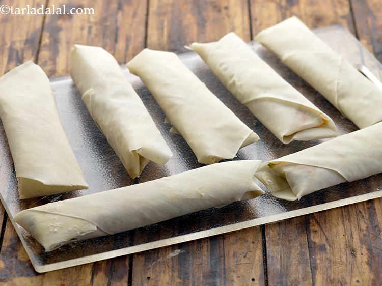 Step 24 – Repeat steps 2 to 7 to make 6 more indo-chinese <strong>Spring rolls</strong>. Keep them covered …