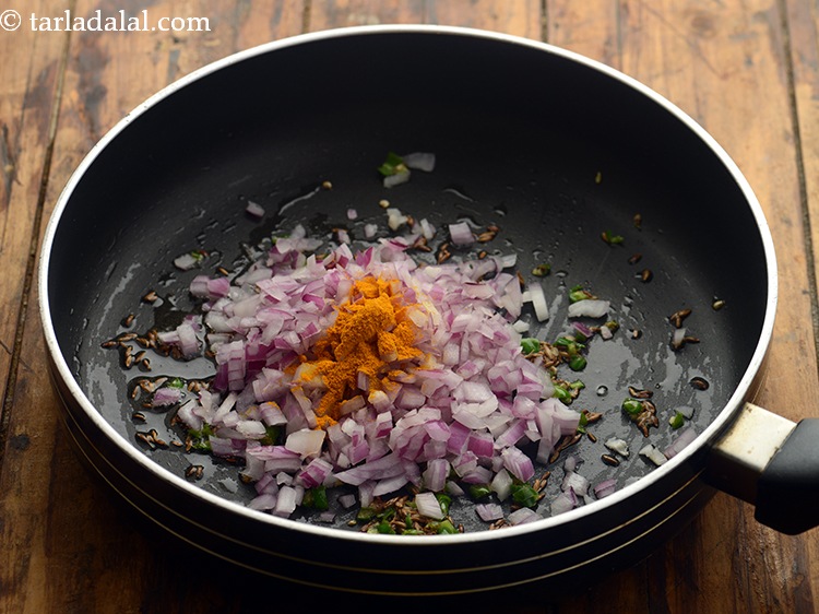 Step 17 – Add the turmeric powder. To make the <strong>sprouted matki poha</strong> spicier, add red chilli powder.