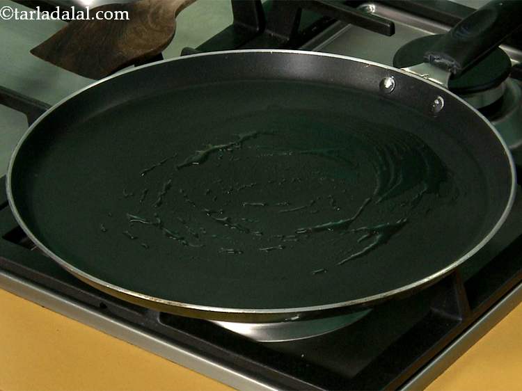 Step 17 – Heat and grease a non-stick tava (griddle) using &frac14; tsp of oil.