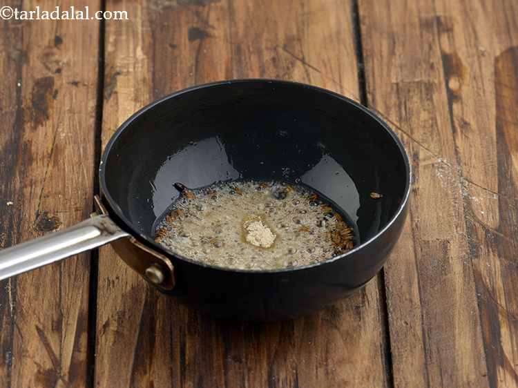 Step 13 – When they crackle, add the asafoetida and mix well.