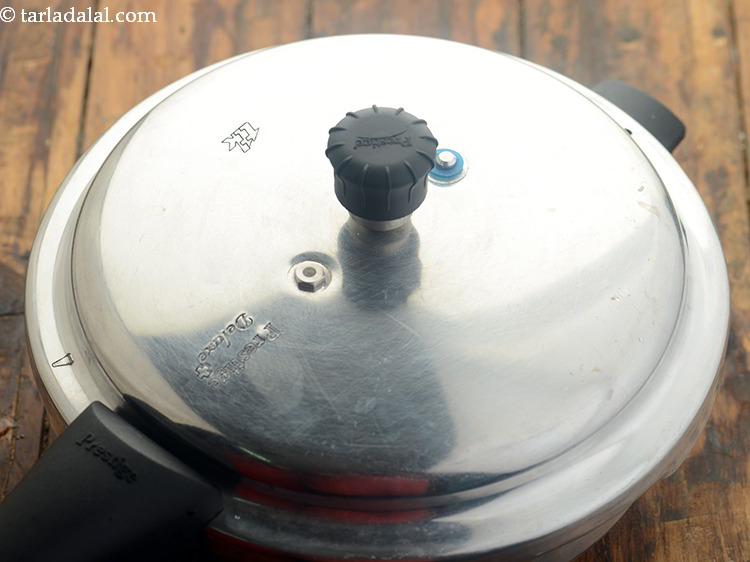 Step 23 – Cover it with a ladle and pressure cook for 3 whistles.