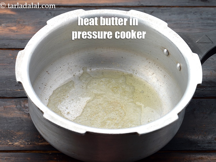 Step 3 – Heat 1 tsp&nbsp;<a href="https://www.tarladalal.com/glossary-low-fat-butter-low-cal-butter-butter-substitute-234i">butter</a> in a pressure cooker.&nbsp;
