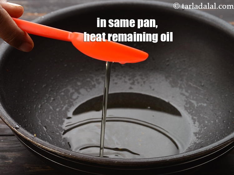 Step 28 – In the same deep pan, heat the remaining 1 tbsp of <a href="https://www.tarladalal.com/glossary-oil-671i">oil</a>.&nbsp;