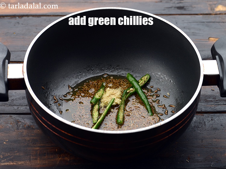 Step 14 – Add 3&nbsp;<a href="https://www.tarladalal.com/glossary-sliced-green-chillies-936i">sliced green chillies</a>.