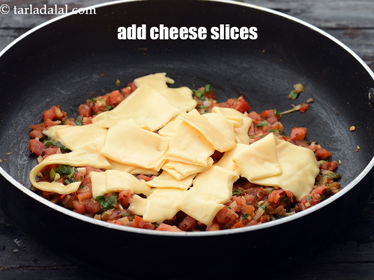 Step 13 – Add 4&nbsp;Britannia&nbsp;<a href="https://www.tarladalal.com/glossary-cheese-slices-765i">cheese slices</a>&nbsp;, torn into pieces.&nbsp;