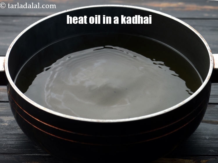 Step 16 – Heat the oil in a kadhai.