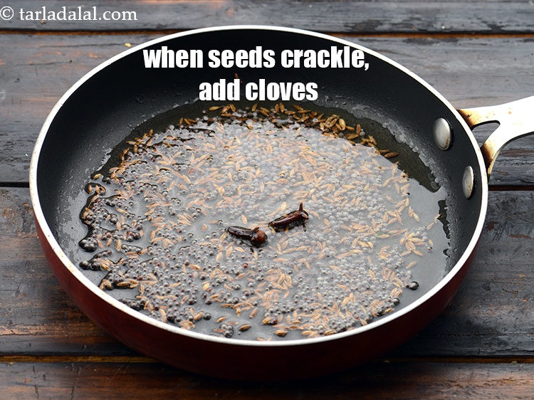 Step 24 – When the seeds crackle, add 2&nbsp;<a href="https://www.tarladalal.com/glossary-cloves-laung-lavang-322i">cloves (laung / lavang)</a>.