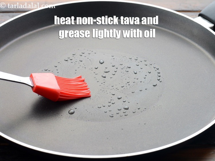Step 20 – Heat a non-stick tava (griddle) and grease it lightly with <a href="https://www.tarladalal.com/glossary-oil-671i">oil</a>.