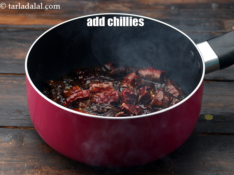 Step 4 – Add 7 to 8 <a href="https://www.tarladalal.com/glossary-whole-dry-kashmiri-red-chillies-kashmiri-mirch-kashmiri-lal-mirch-332i">whole dry kashmiri red chillies</a>, broken into pieces.&nbsp;