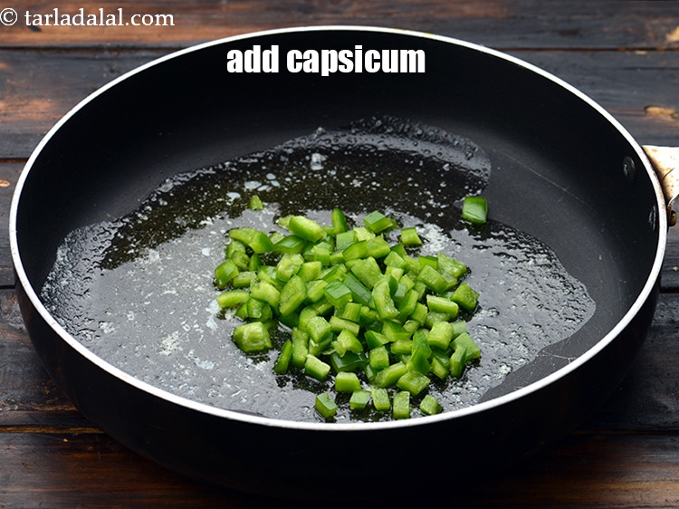 Step 13 – Add&nbsp;1/4 cup&nbsp;<a href="https://www.tarladalal.com/glossary-chopped-capsicum-164i">chopped capsicum</a>.&nbsp;