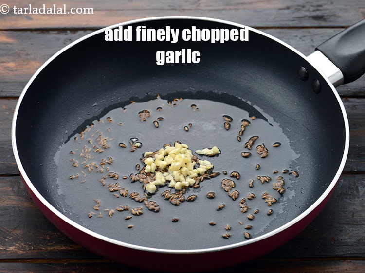 Step 5 – When the seeds crackle, add 1 tsp&nbsp;finely&nbsp;<a href="https://www.tarladalal.com/glossary-chopped-garlic-790i">chopped garlic (lehsun)</a>.