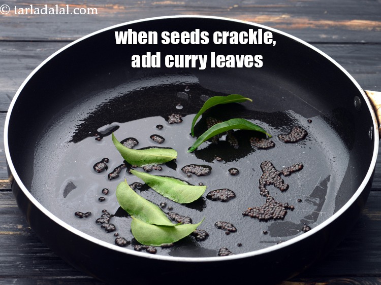Step 9 – When the seeds crackle, add 6&nbsp;<a href="https://www.tarladalal.com/glossary-curry-leaves-kadi-patta-kadipatta-388i">curry leaves (kadi patta)</a>.&nbsp;