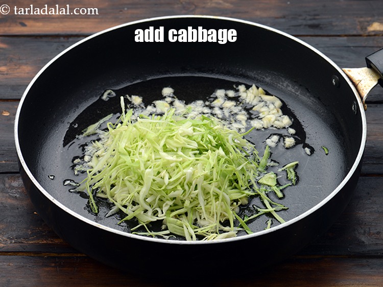 Step 19 – Add 3/4 cup&nbsp;<a href="https://www.tarladalal.com/glossary-shredded-cabbage-763i">shredded cabbage</a>. It should be very thinly shredded.&nbsp;