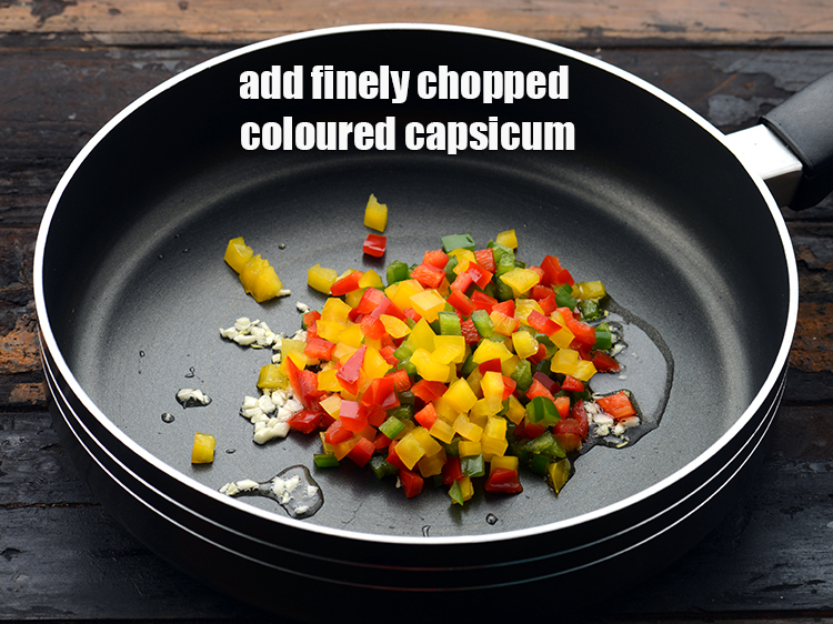 Step 11 – Add 1/2 cup&nbsp;chopped capsicum (<a href="https://www.tarladalal.com/glossary-chopped-red-capsicum-2299i">red</a>,&nbsp;<a href="https://www.tarladalal.com/glossary-chopped-yellow-capsicum-2300i">yellow</a>&nbsp;and&nbsp;<a href="https://www.tarladalal.com/glossary-chopped-capsicum-164i">green</a>).
