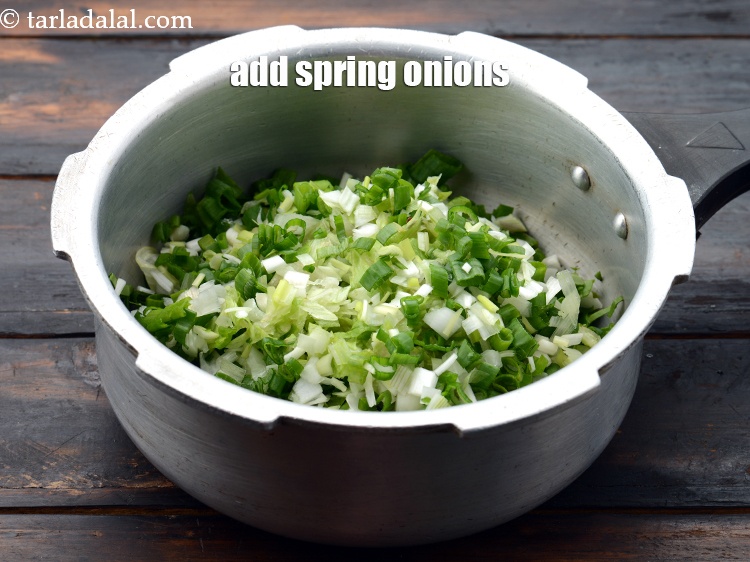 Step 6 – Add 3/4 cup&nbsp;<a href="https://www.tarladalal.com/glossary-chopped-spring-onions-1575i">chopped spring onions</a>&nbsp;(whites and greens).