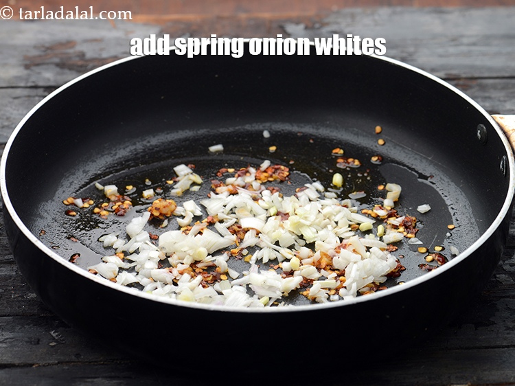 Step 7 – Add 1/4 cup&nbsp;finely&nbsp;<a href="https://www.tarladalal.com/glossary-chopped-spring-onion-whites-815i">chopped spring onions whites</a>.&nbsp;