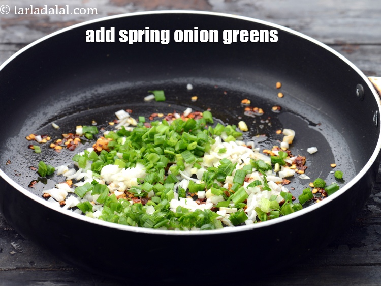 Step 8 – Add 1/4 cup&nbsp;finely&nbsp;<a href="https://www.tarladalal.com/glossary-chopped-spring-onion-greens-1030i">chopped spring onion greens</a>.&nbsp;