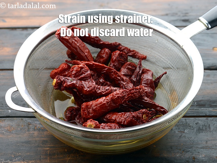 Step 9 – Drain the red chillies using a strainer. Do not discard the water.&nbsp;