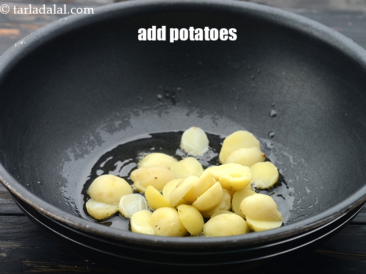 Step 25 – Add 1/2 cup&nbsp;<a href="https://www.tarladalal.com/glossary-boiled-and-peeled-baby-potatoes-2222i">boiled and peeled baby potatoes</a>&nbsp;, cut into halves vertically.&nbsp;