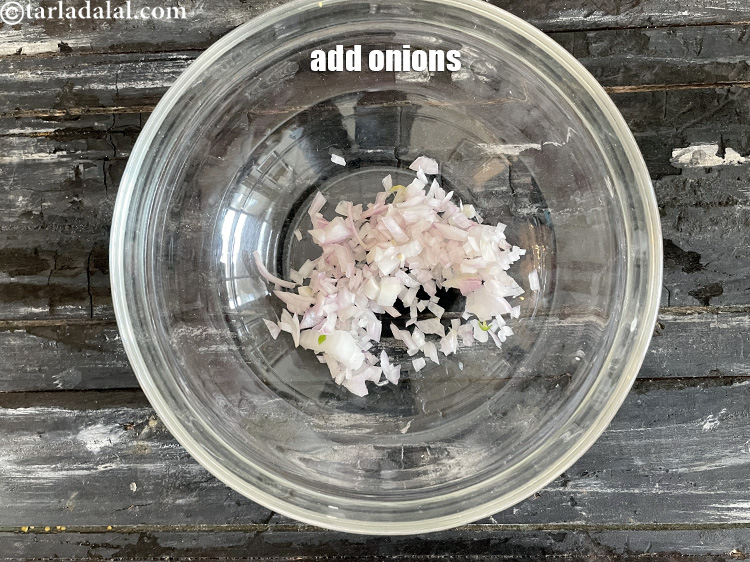 Step 23 – We are making the topping for vegetable rava uttapam. In a bowl put 3/4 cup …