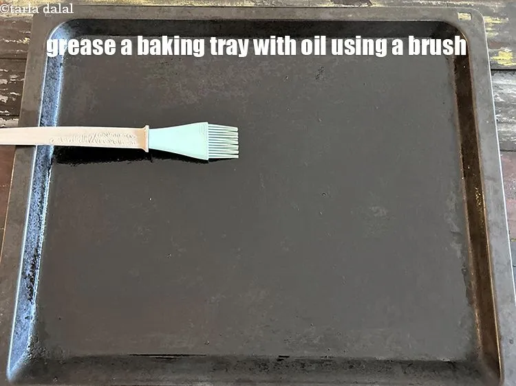 Step 17 – <html><head><meta charset="UTF-8"> </head><body><p>Grease a baking tray with oil using a brush.</p></body></html>