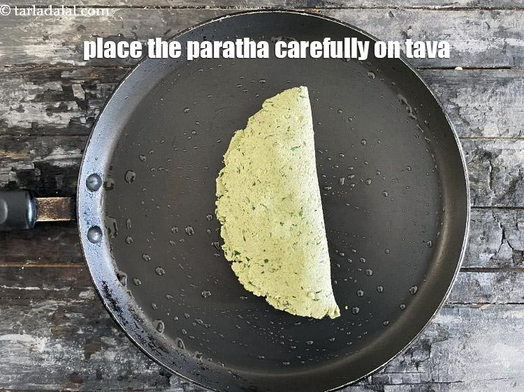 Step 31 – Lift the paratha carefully and place it on a non-stick pan.