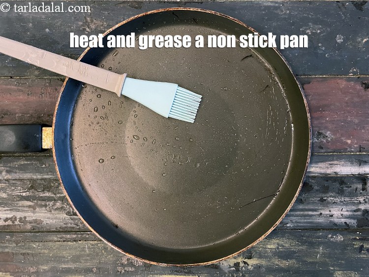 Step 29 – <meta charset="UTF-8" />Heat a non-stick tava (griddle) and grease it with oil.&nbsp;