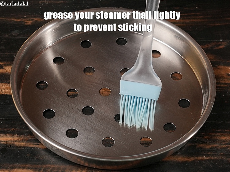 Step 32 – Grease your steamer thali lightly to prevent sticking.