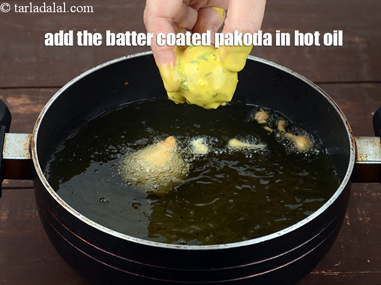 Step 35 – Add the batter coated pakoda in hot oil.