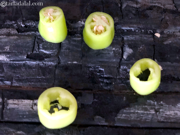 Step 2 – Take bhavnagri chillies and cut into 12 mm roundels. You need to push the seeds …